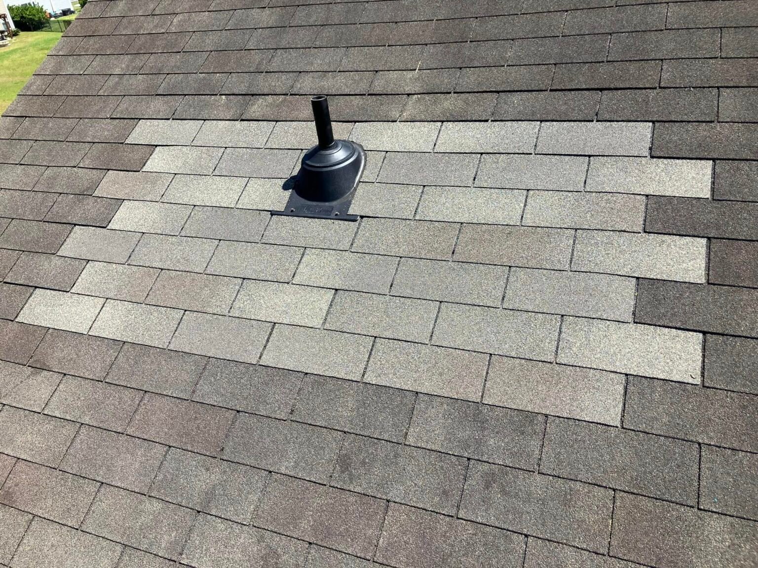 roof repair in RIdgeland. New shingles patching a hole in the roof