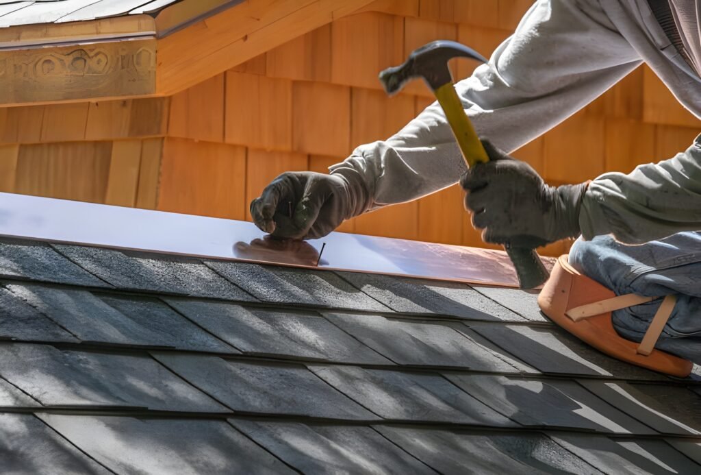 Roofer installing metal flashing on an asphalt shingle roof using a hammer and nails for weatherproofing. Roof flashing repair in Bluffton.