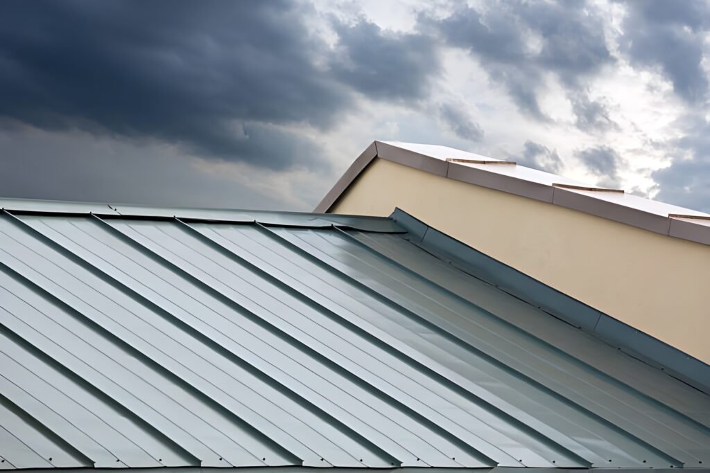 Close-up of a standing seam metal roof on a modern building with storm clouds in the background